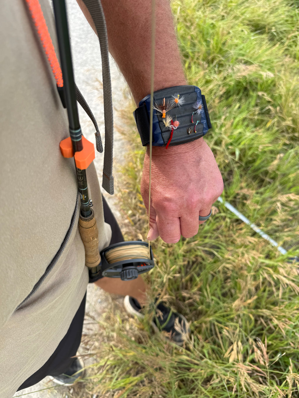 Fly rod clip for vest or chest pack