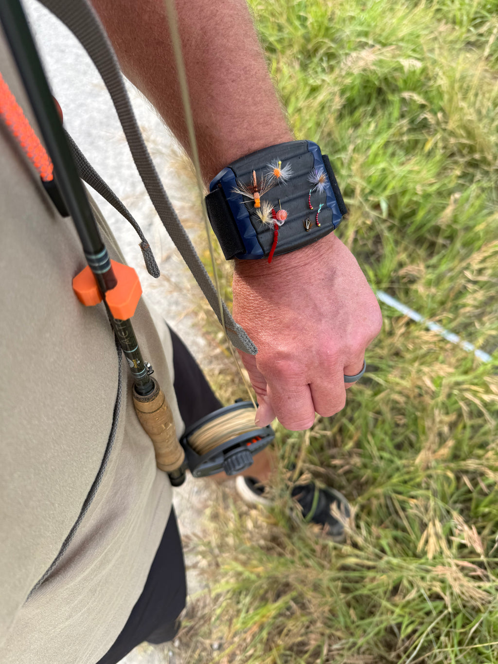Fly rod clip for vest or chest pack