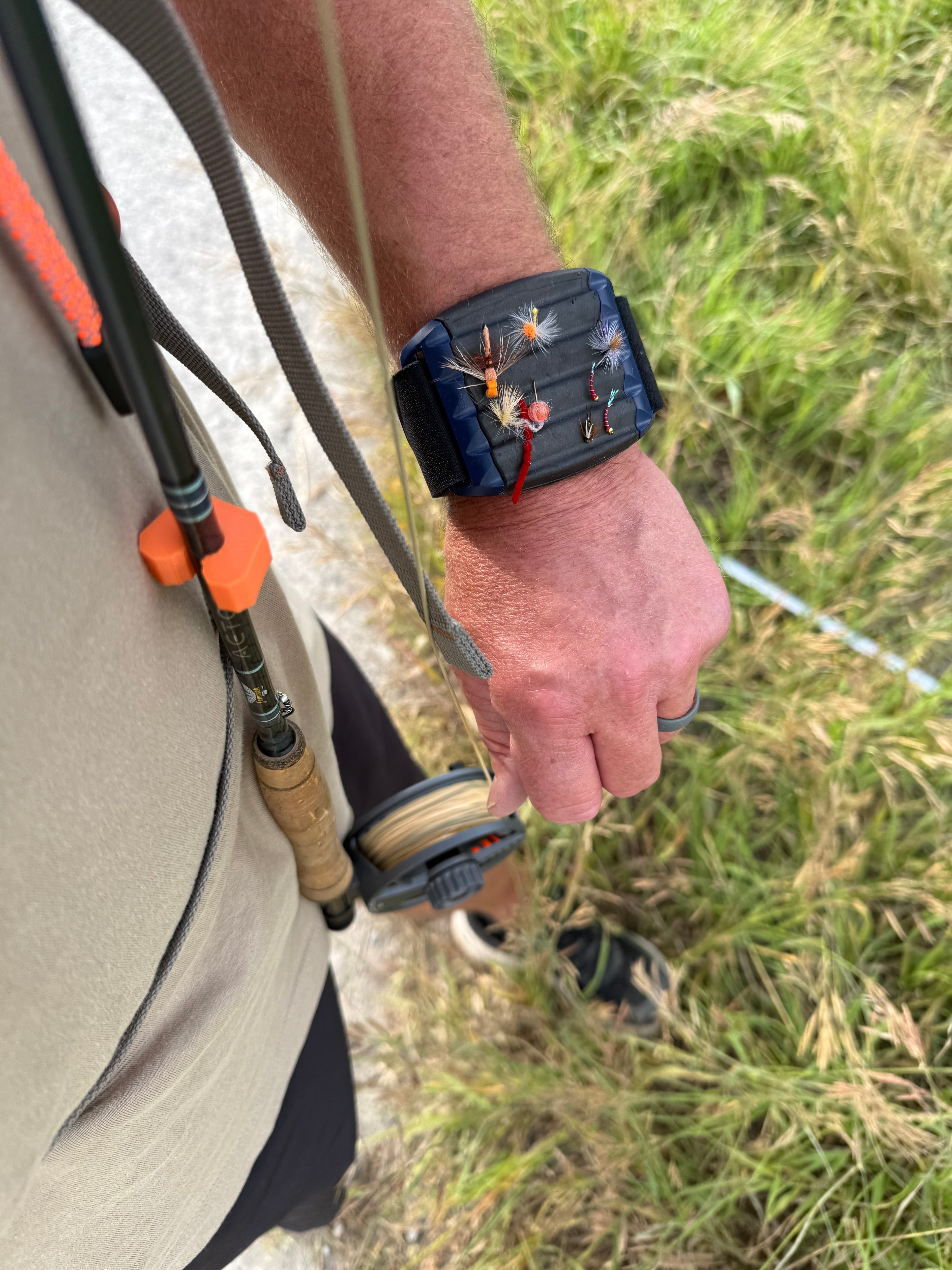 Fly rod clip for vest or chest pack
